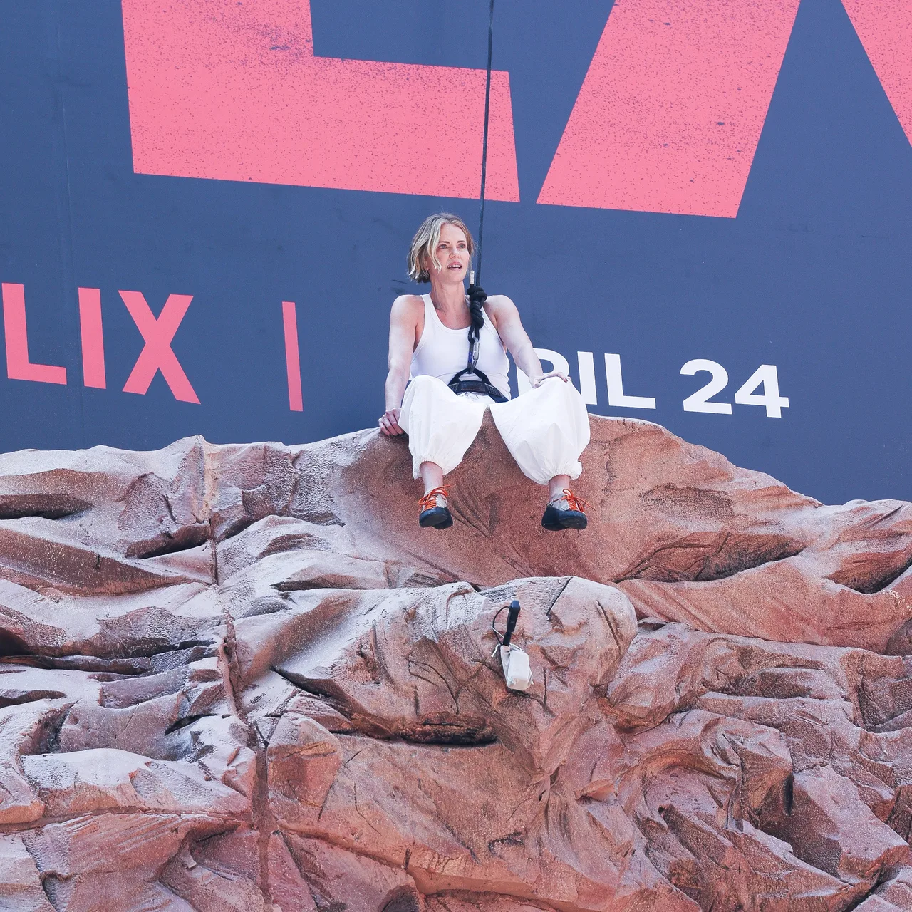 Theron successfully completed the climb and sat in front of the ‘Apex’ billboard