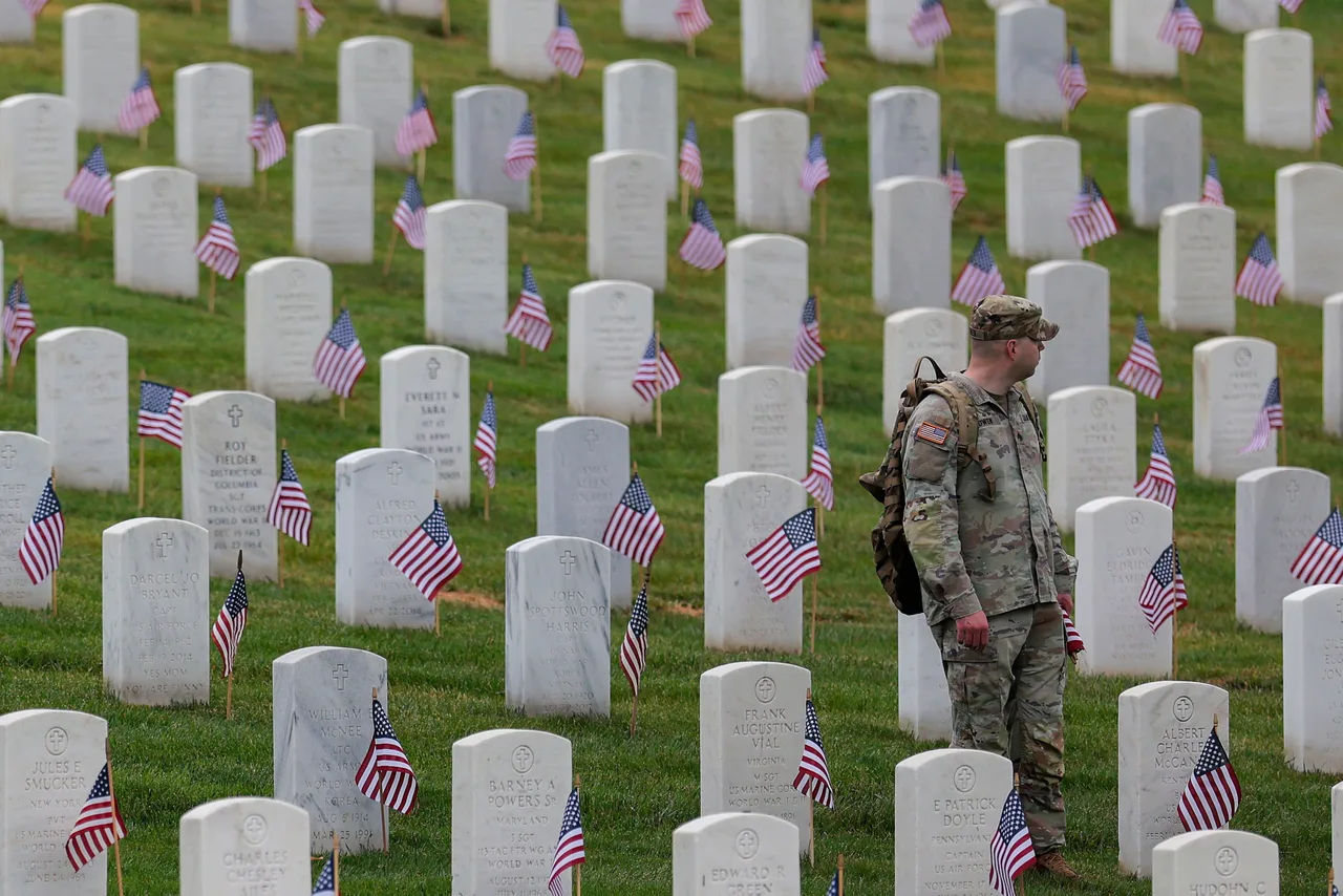 Members of the 3rd U.S. Infantry Regiment place flags in front of each headstone at Arlington National Cemetery on May 21, 2026 in Arlington, Virginia. Before dawn soldiers begin the process of placing a flag in front of approximately 260,000 headstones ahead of Memorial Day.
