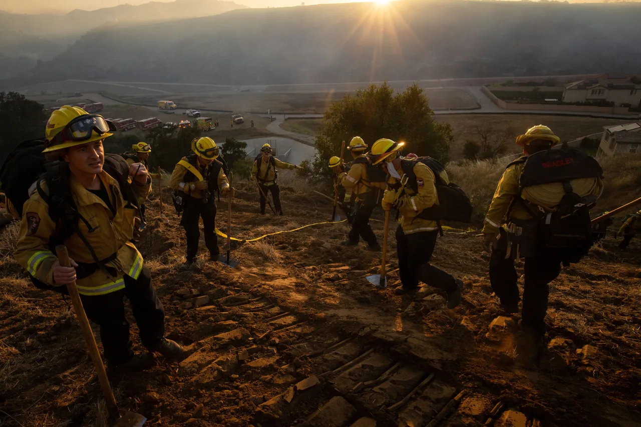 Fire crews battle the Sandy Fire Monday as morning approaches