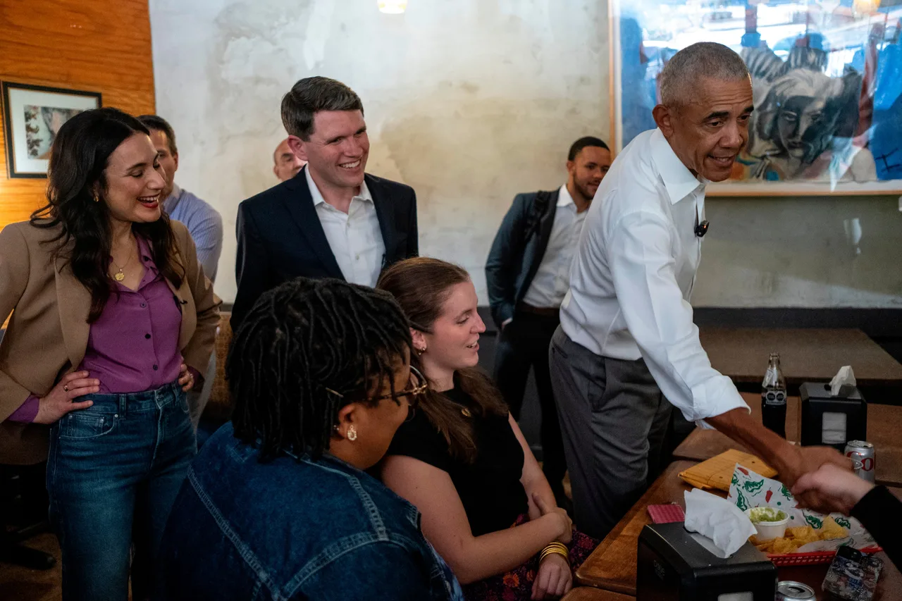 Obama shakes hands with voters as Talarico looks on