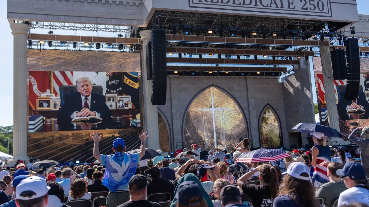 A person worships as a recorded video message from President Donald Trump plays at Rededicate 250, a mostly conservative Christian prayer gathering in honor of the United States' 250th anniversary, on the National Mall, Sunday, May 17, 2026, in Washington. (AP Photo/Julia Demaree Nikhinson)