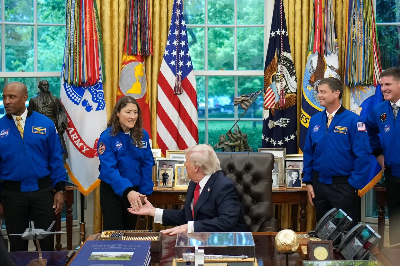 Astronauts flank Trump at Resolute Desk