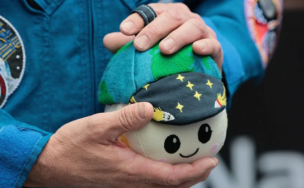 Artemis II Moon Mascot, Rise, pictured in the hands of Commander Reid Wiseman outside Nasdaq Marketside on April 30, 2026