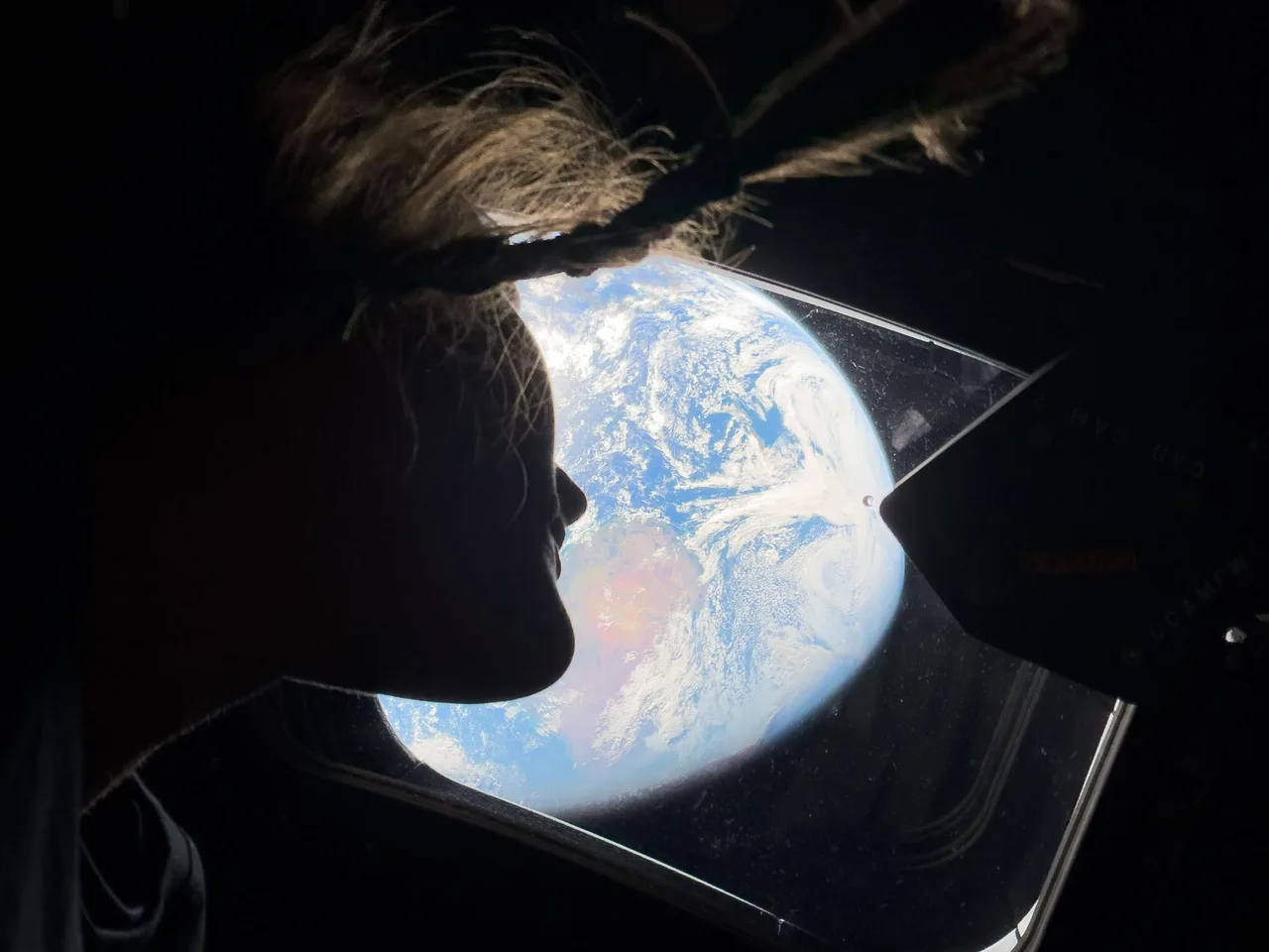 Mission Specialist Christina Koch looking at Earth