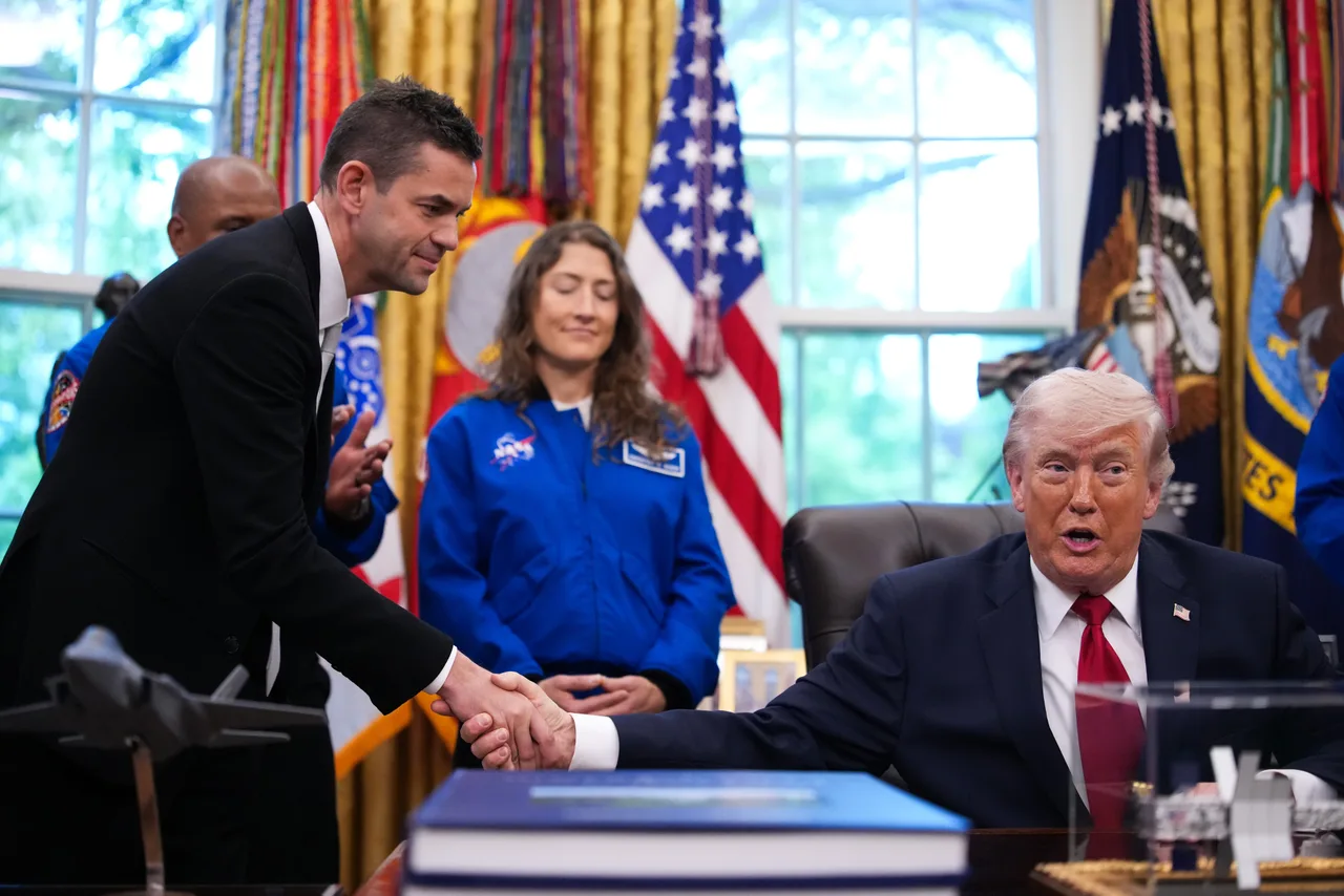 Trump and Isaacman greet one another