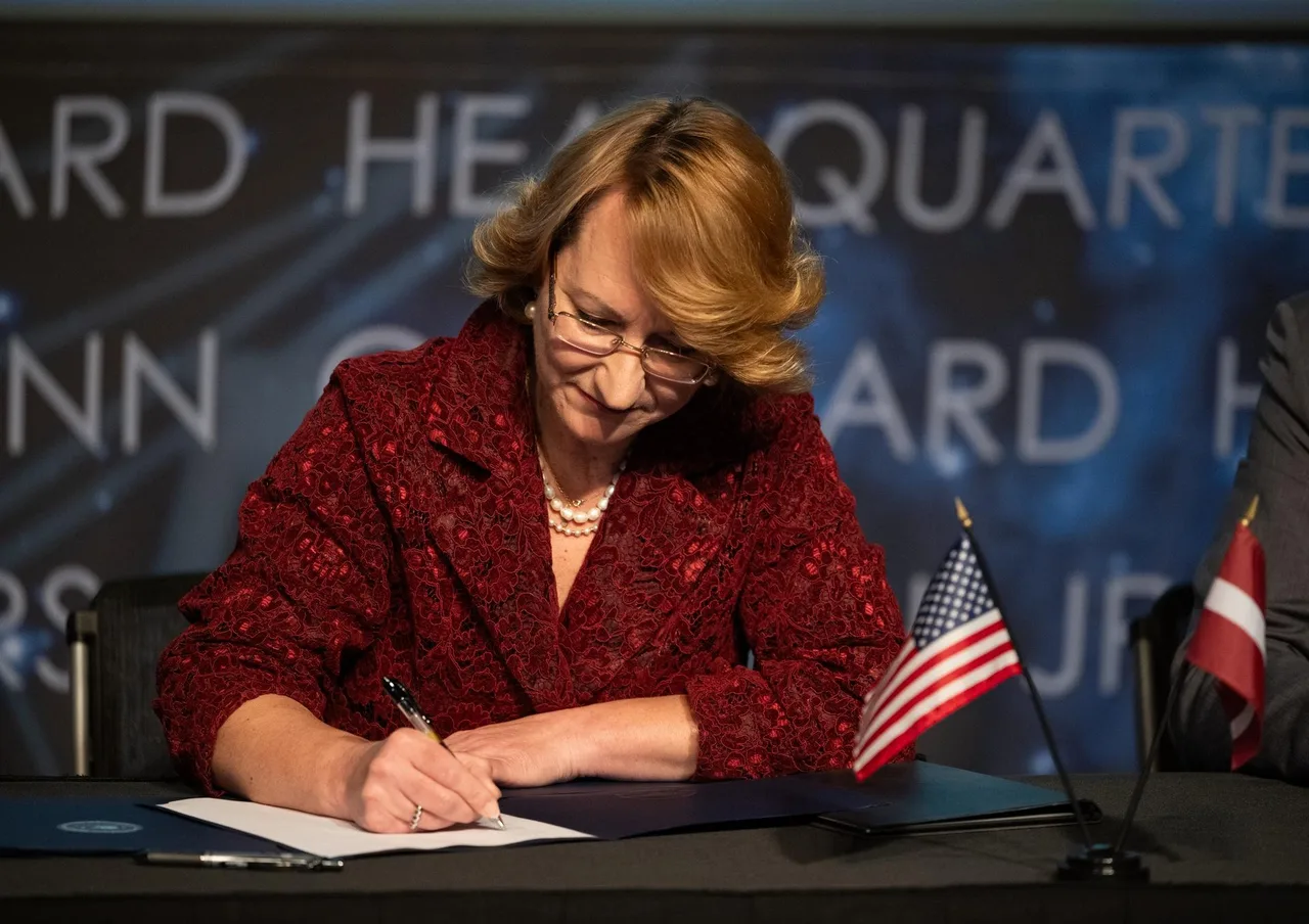 Latvia’s Minister for Education and Science signing the Artemis Accords
