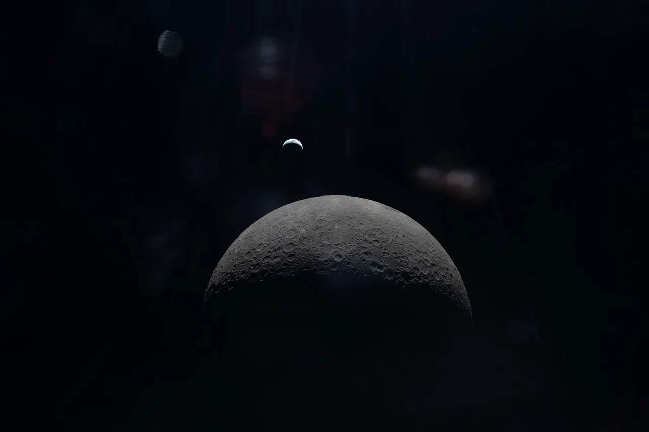 Crescent Earth floating above rugged lunar terrain