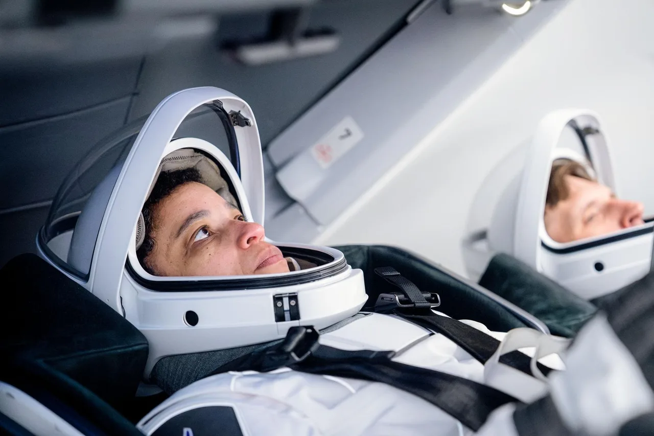 Jessica Watkins and Joshua Kutryk seated inside Dragon