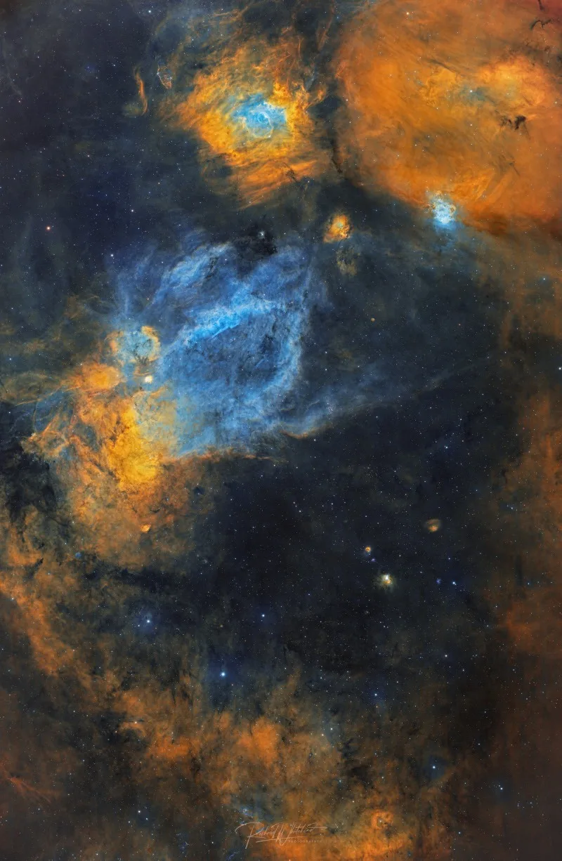The Claw and Bubble Nebula glowing bright in a cosmic color clash