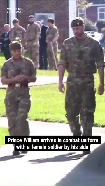 Prince William arrives in combat uniform with a female soldier by his side