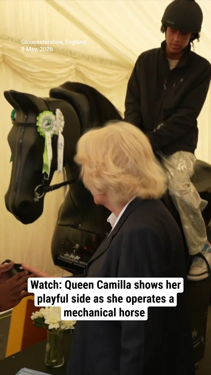 Watch: Queen Camilla shows her playful side as she operates a mechanical horse during royal outing