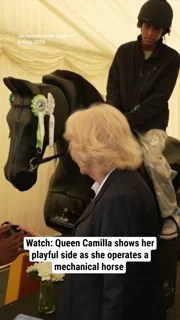 Watch: Queen Camilla shows her playful side as she operates a mechanical horse during royal outing