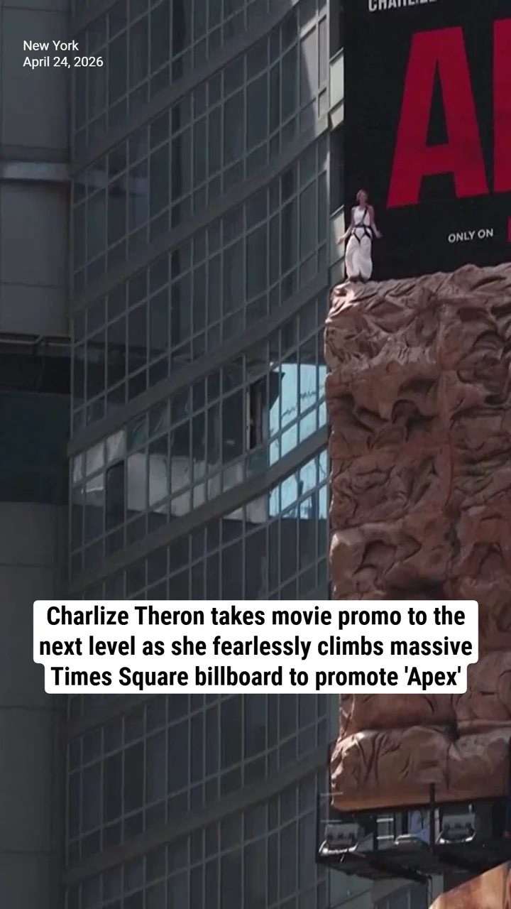 Charlize Theron takes movie promo to the next level as she fearlessly climbs massive Times Square billboard to promote 'Apex'