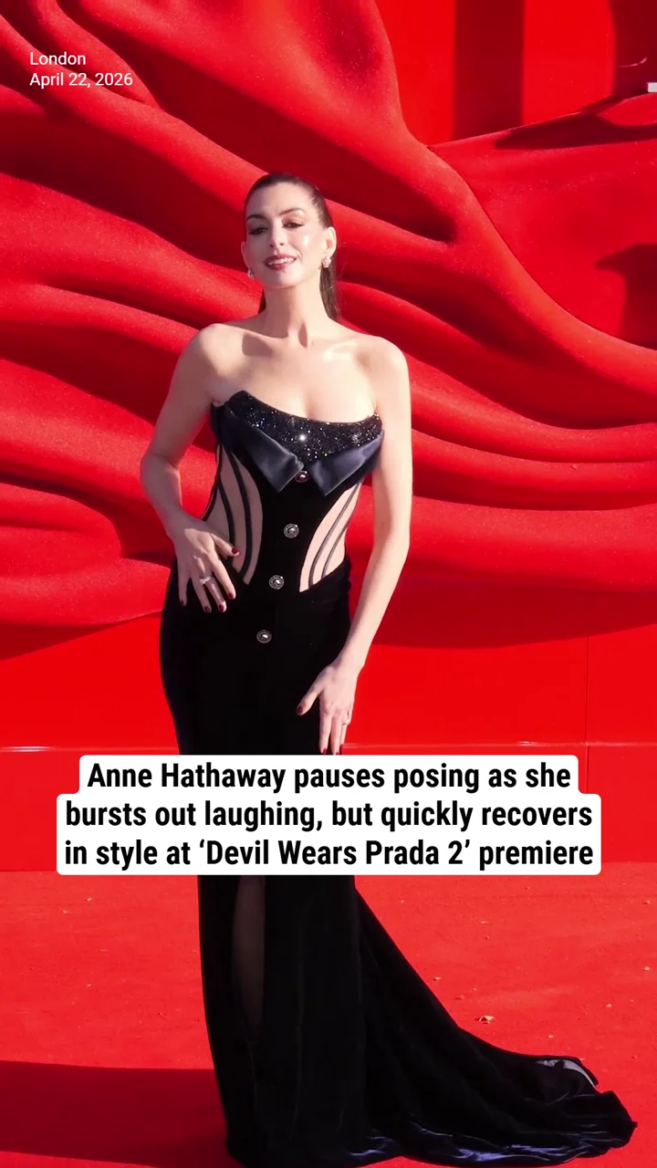 Anne Hathaway pauses posing as she bursts out laughing, but quickly recovers in style at ‘Devil Wears Prada 2’ premiere