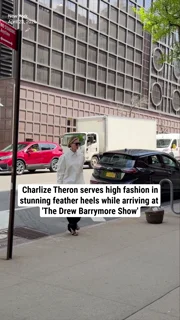 Charlize Theron serves high fashion in stunning feather heels while arriving at 'The Drew Barrymore Show'