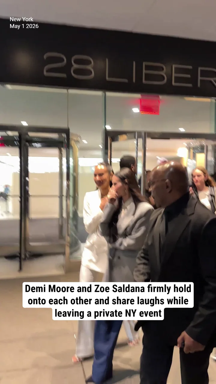 Demi Moore and Zoe Saldana firmly hold onto each other and share laughs while leaving a private NY event