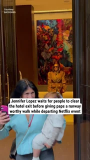 Jennifer Lopez waits for people to clear the hotel exit before giving paps a runway worthy walk while departing Netflix event