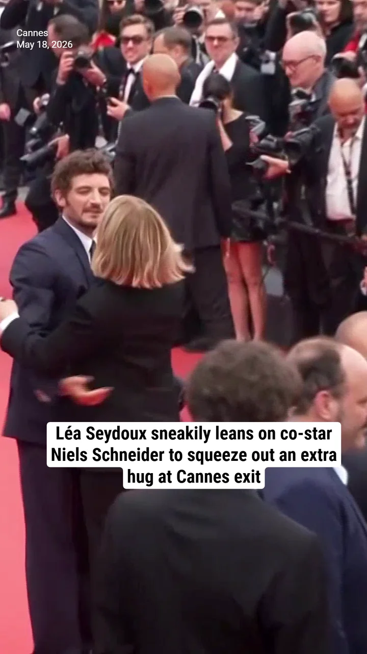 Léa Seydoux sneakily leans on co-star Niels Schneider to squeeze out an extra hug at Cannes exit