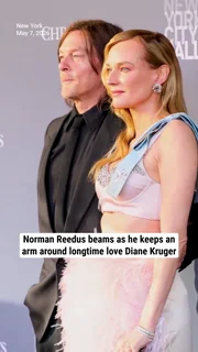 Norman Reedus beams as he keeps an arm around longtime love Diane Kruger