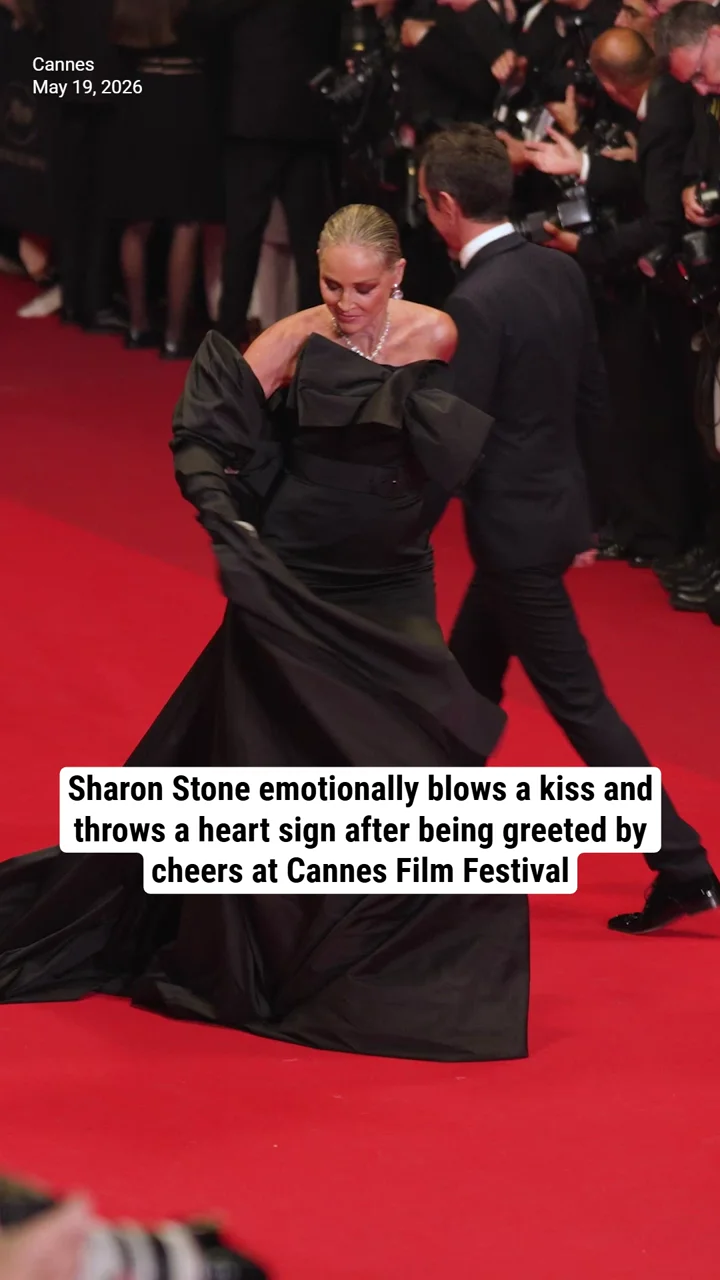 Sharon Stone emotionally blows a kiss and throws a heart sign after being greeted by cheers at Cannes Film Festival